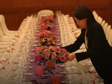 beginners class banquet table with staff arranging flowers decoration